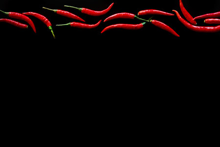 Red hot chili peppers on black background. Top view. Copy space.の写真素材