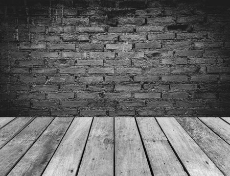 Empty room with old brick wall and wood floor. Vintage background.の写真素材