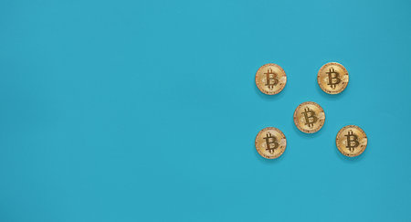 Bitcoin coins on a blue background. Cryptocurrency and finance concept.の写真素材