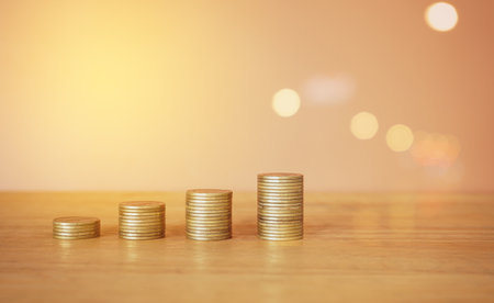 Stack of coins with bokeh light background, business and finance conceptの写真素材