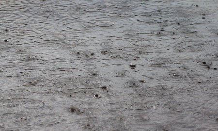 raindrops on a puddle on the road, close-upの写真素材