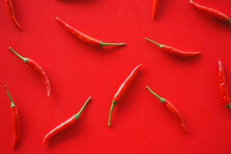 Red hot chili peppers on a red background. Flat lay, top viewの写真素材