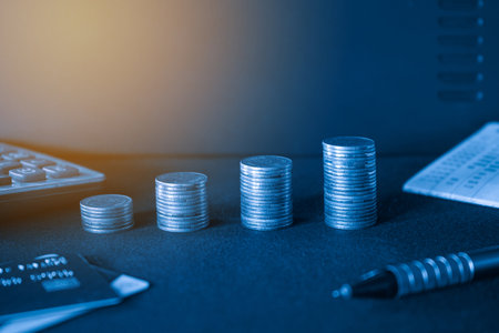 Stacks of coins and credit card on dark background, finance and banking concept.の写真素材