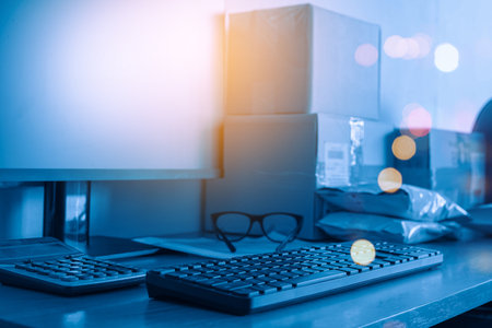 Office desk with computer, supplies and smartphone. Blurred background.の写真素材