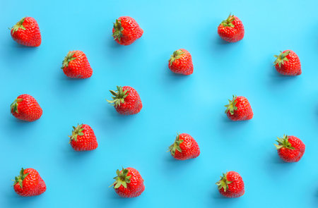 Strawberry pattern on blue background. Flat lay, top viewの写真素材