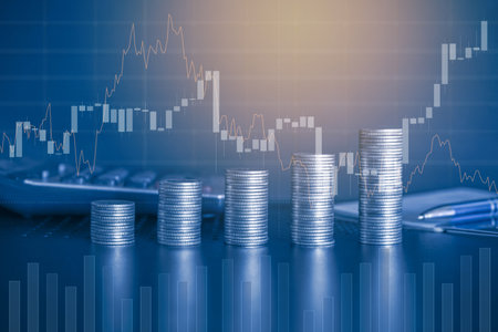 Investment concept, Coins graph stock market financial on LED background.の写真素材
