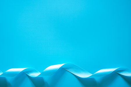 Blue satin ribbon on blue background. Copy space for text.の写真素材