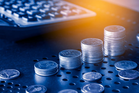 Coins on the table with calculator. Business and finance concept.の写真素材