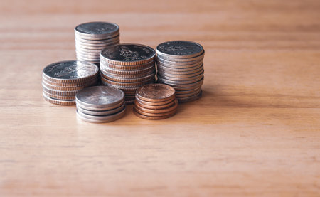 Stack of coins on wooden background, business and finance concept idea.の写真素材