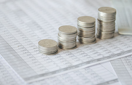 Coins on the table of financial data, business planning and finance conceptの写真素材