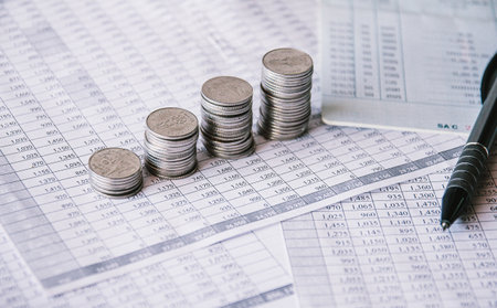 Stacks of coins on finance account book with pen, business conceptの写真素材
