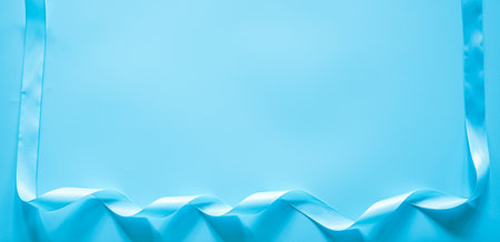 Blue silk ribbon on a blue background with copy space for text.の写真素材