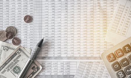 Accounting concept. Coins, calculator and financial documents on the table.の写真素材