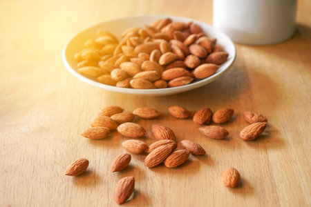 Almond in white bowl on wooden table. Almond background.の写真素材