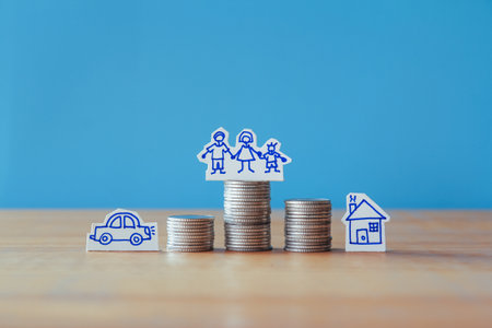 Saving money for buy a house concept, coins stack with family icon on blue backgroundの写真素材