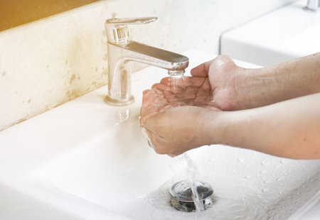 Washing hands with soap under running water. Hygiene concept.の写真素材