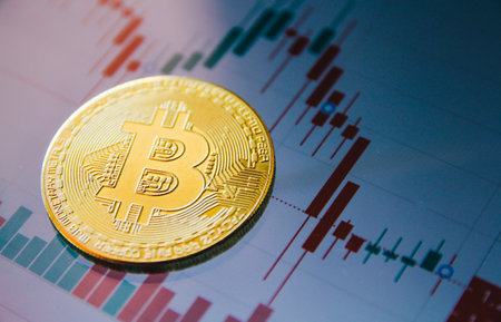 golden bitcoin on the background of the financial chart, close-upの写真素材