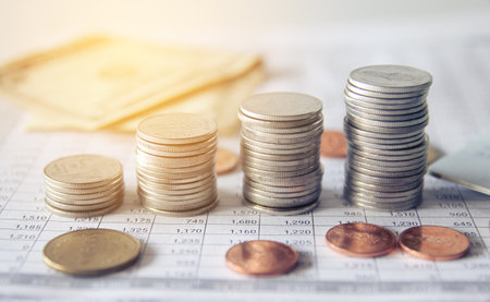 Coins stack on finance account book, business and saving concept.の写真素材