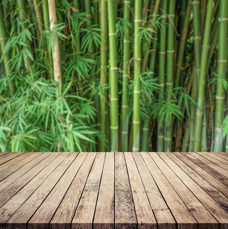 Empty wooden table and bamboo forest background, product display montage.の写真素材