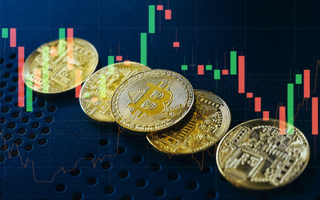 Bitcoin gold coin on the stock market graph background. Cryptocurrency concept.の写真素材
