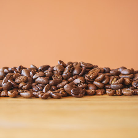 Coffee beans on wooden table. Coffee beans on brown backgroundの写真素材