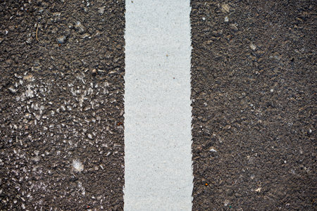 White line on the asphalt road. Abstract background and texture for design.の写真素材