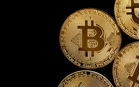 Golden bitcoin on black background. Digital currency. Cryptocurrency concept.の写真素材