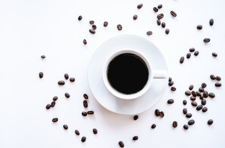 Coffee cup and coffee beans on white background, top viewの写真素材