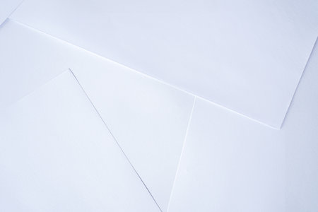 White paper background with soft shadows and copy space for design work.の写真素材