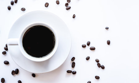 Coffee cup and coffee beans on white background, top viewの写真素材