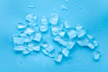 Ice cubes on blue background. Top view. Copy space for text.の写真素材