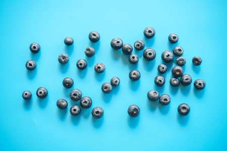 Blueberries on a blue background. Top view, flat lay.の写真素材