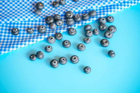Blueberries on blue background. Blueberries on blue tablecloth.