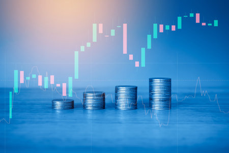 Stacks of coins with financial graph on blue background, business and financial conceptの写真素材