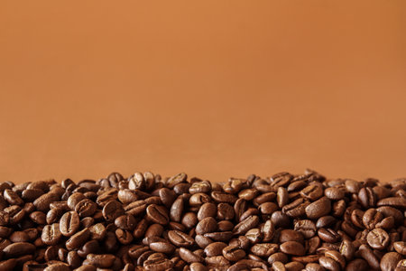 coffee beans on brown background with copy space, can be used as a backgroundの写真素材