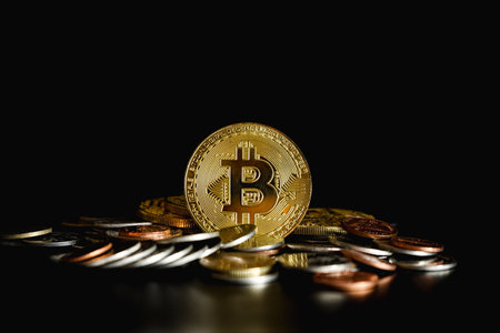 Golden bitcoin on black background. Bitcoin is a modern way of exchange and this crypto currency is a convenient means of payment in the financialの写真素材