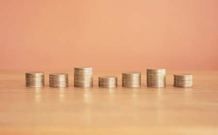 Stack of coins on wooden table with copy space, business growth conceptの写真素材