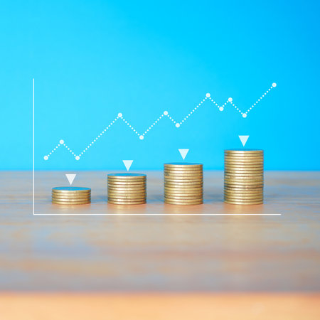 Stacks of coins with graph on blue background, business and financial concept