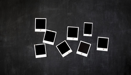 Blank retro frames attached to a vintage metal blackboard with magnetsの写真素材