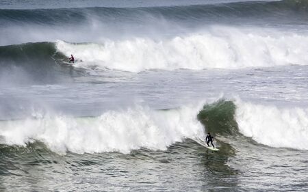 Bells Beach, Torquay/Australia  April 27, 2019: Heat 1 of Rip Curl Pro menï¿½s semifinal of World Surf League, Filipe Toledo (foreground) winning over Ryan Callinan at monster swells of Bells Beach.のeditorial素材