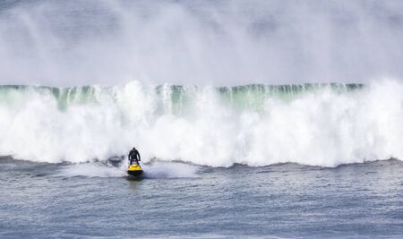 Bells Beach, Torquay/Australia April 27, 2019:  A jet ski aiding pro surfers competing at Rip Curl Pro is avoiding breaking swellsのeditorial素材