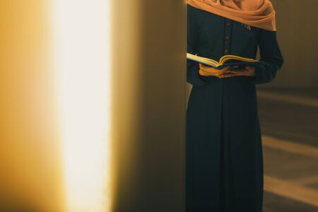 Young muslim woman read Quran in mosque at the Ramadan timeの写真素材