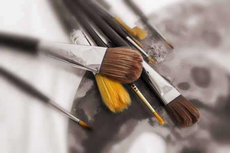 Different Paint Brushes on Palette Close-up view set of different brushes on a palette