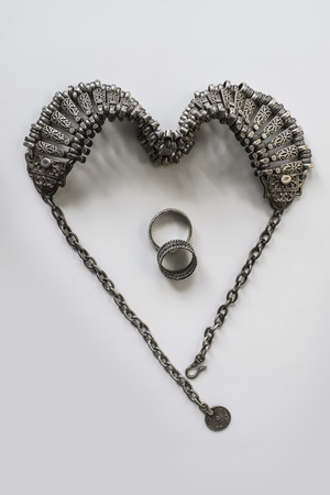 Engraved Jewelry in Shape of Heart with Wedding Ringsの写真素材