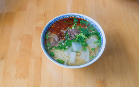 Hand-made halal beef ramen with red chili sauce and white radishの写真素材