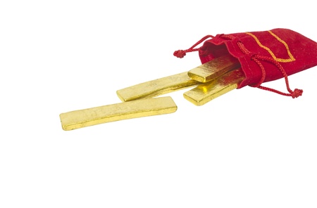 gold bricks drop from red bag on white backgroundの写真素材