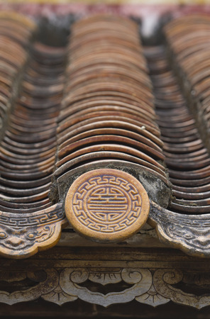 detail of a traditional clay roof at the citadel hue,vietnamの写真素材