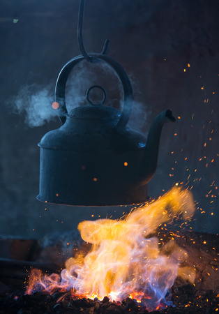 Old iron kettle on the fireの写真素材