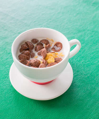 Cornflakes and fresh milk in cup