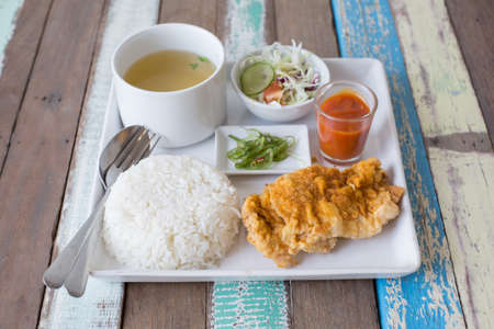 rice with fried chicken with side dishesの写真素材
